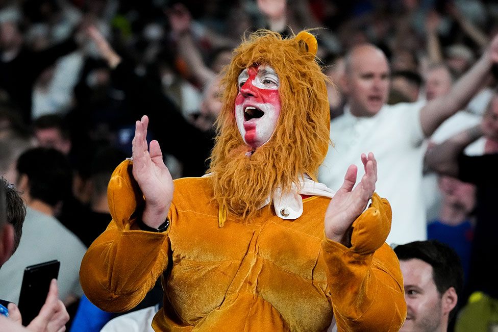 A fan of England dressed as a lion celebrate their side's victory after the UEFA Euro 2020 Championship Semi-final match between England and Denmark at Wembley Stadium