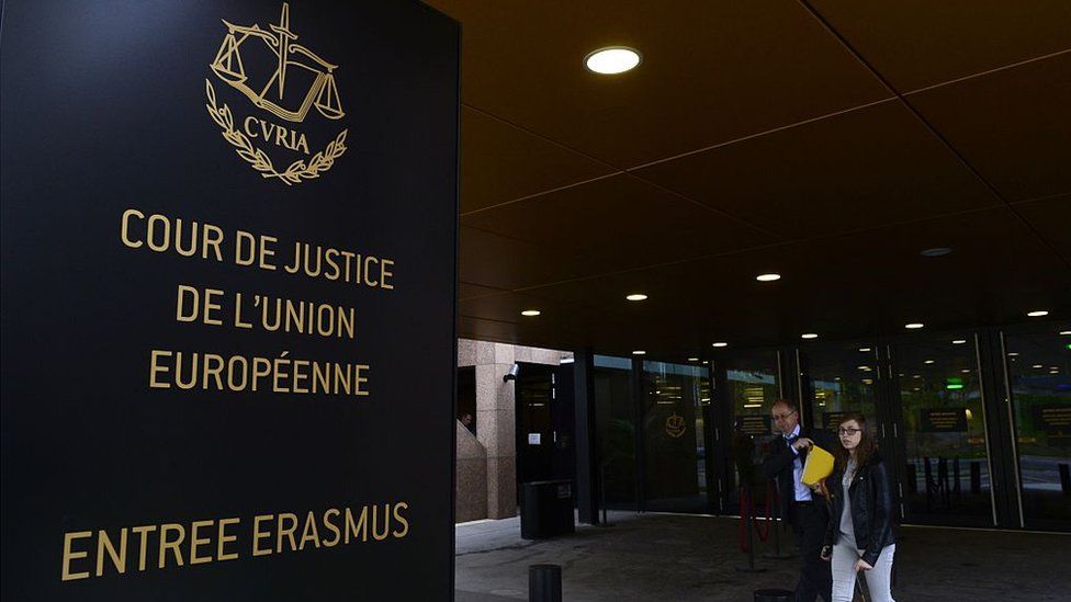 People walk away from the entrance of the European Court of Justice (SCJ) in Luxembourg