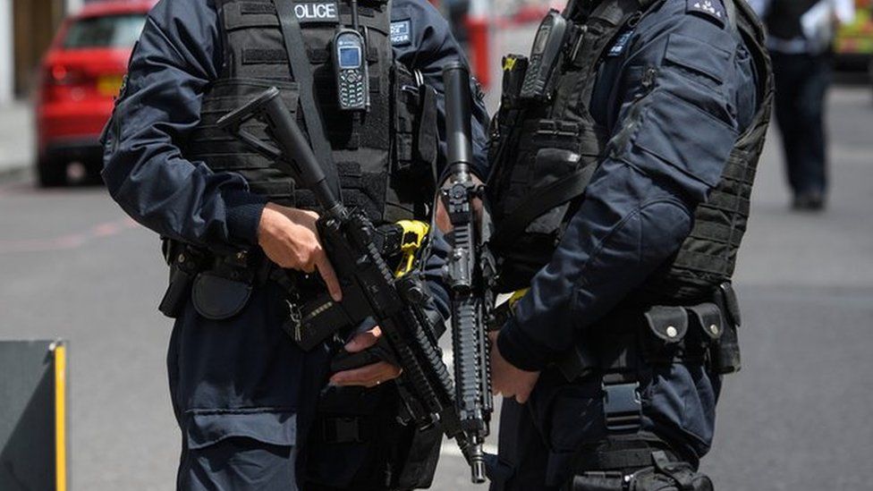 Armed police stand guard near London Bridge station following an attack in the capital, 4 June 2017