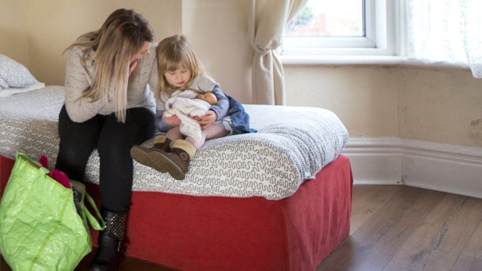 A young mother and daughter in emergency accommodation