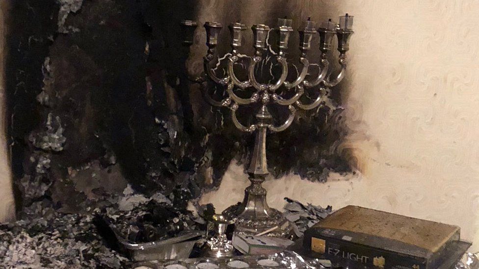 hanukkah candle in burnt room