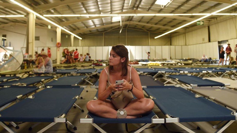 Tourists rest in an evacuation center in La Teste-de-Buch, southwestern France, on July 15, 2022