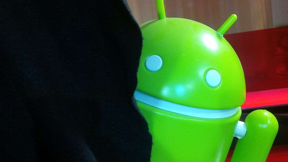 Android mascot behind a curtain