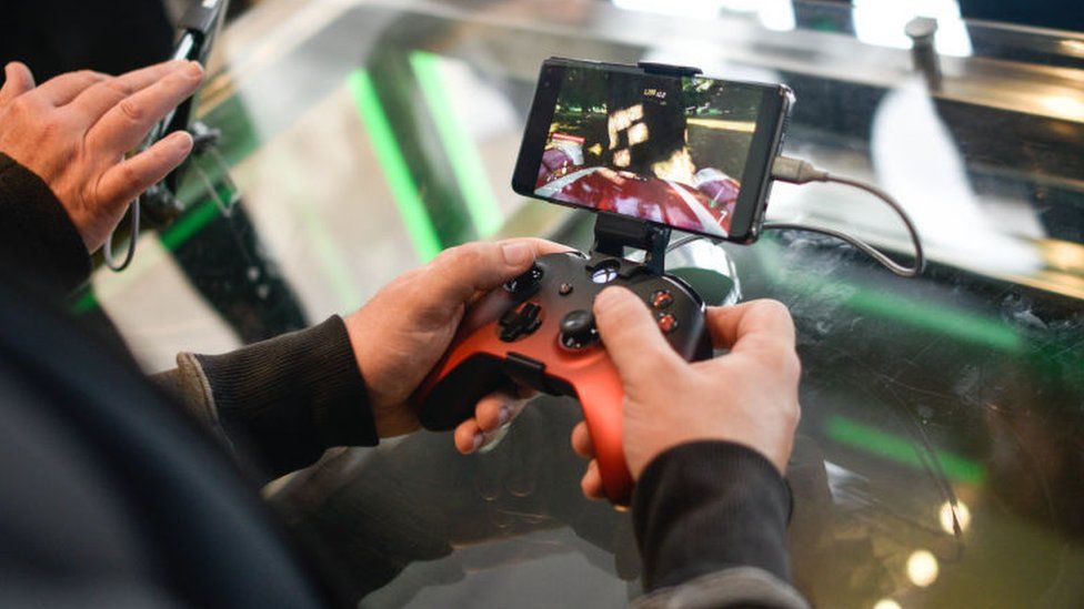 A customer plays on an Xbox xCloud device at the Microsoft store opening on July 11, 2019 in London, England