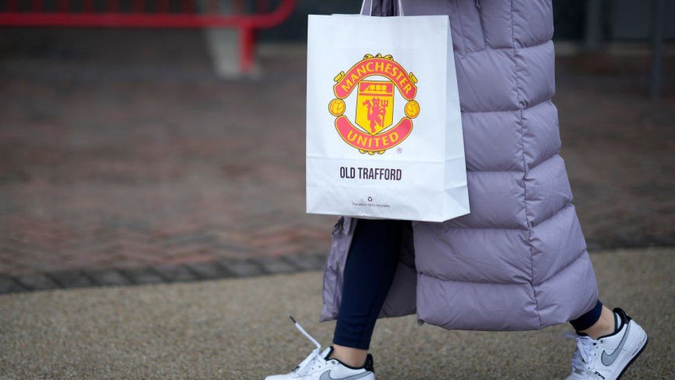 Manchester United supporter with bag