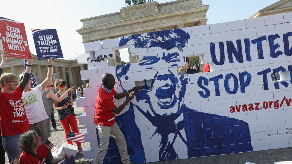 Protestors building a Trump wall