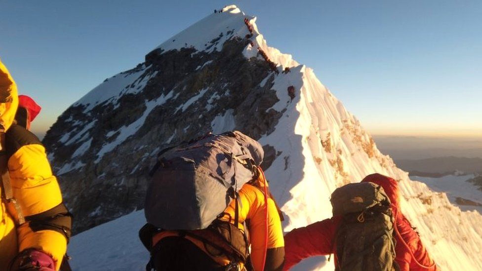 Climbers make their way to the summit of Everest,