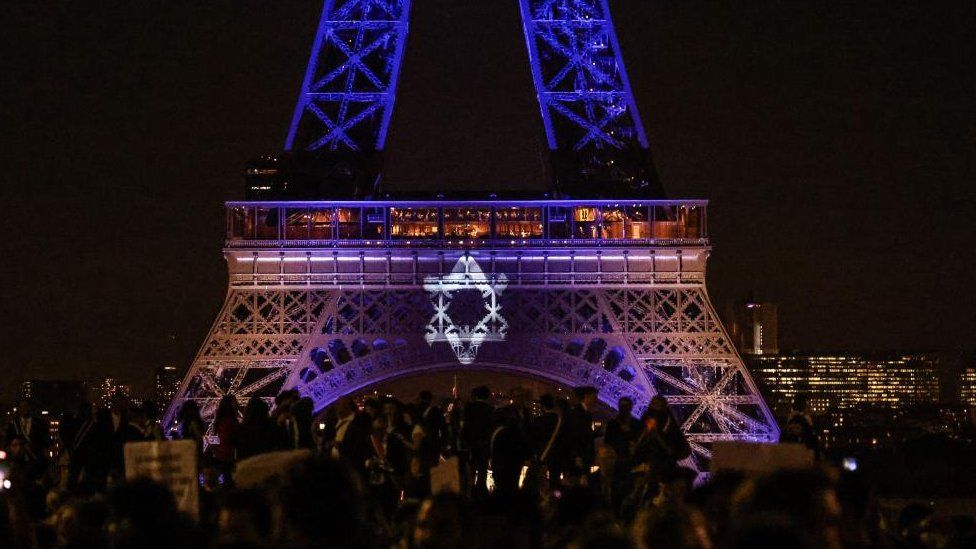 The Eiffel Tower lights up in the colours of the Israeli flag after a Hamas attack killed over 1,300 on 7 October.