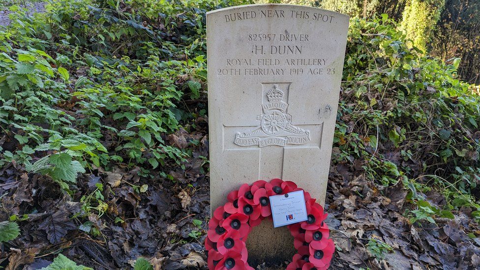 A grave with a poppy on it in Arnos Vale Cemetery in Bristol