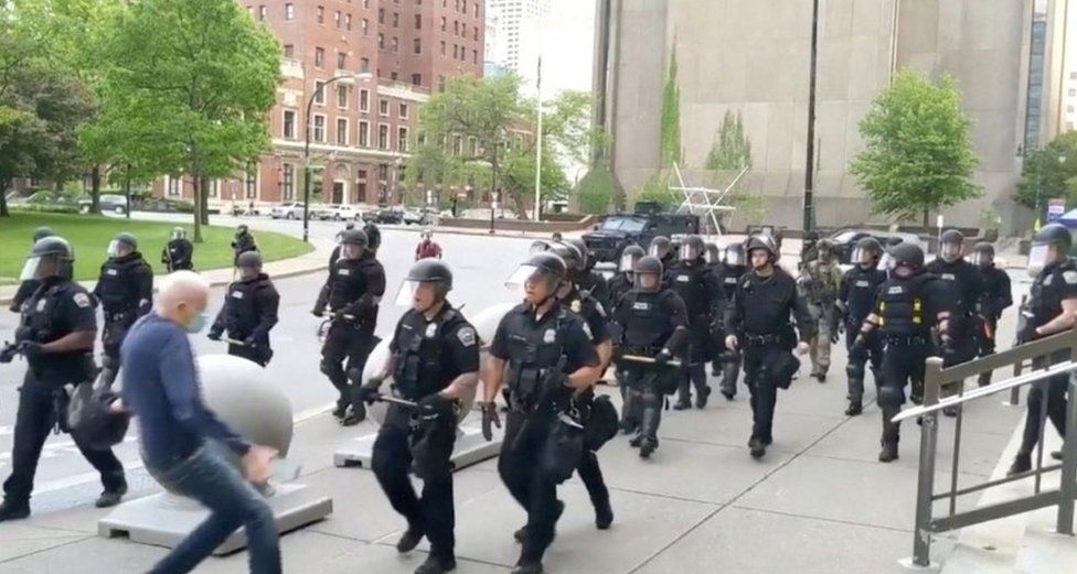 Still image from video of elderly man being pushed by police