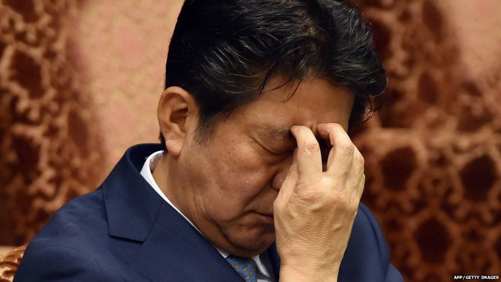 Japan's Prime Minister Shinzo Abe listens to a question by an opposition lawmaker during an Upper House budget committee session at the National Diet in Tokyo on August 10, 2015.
