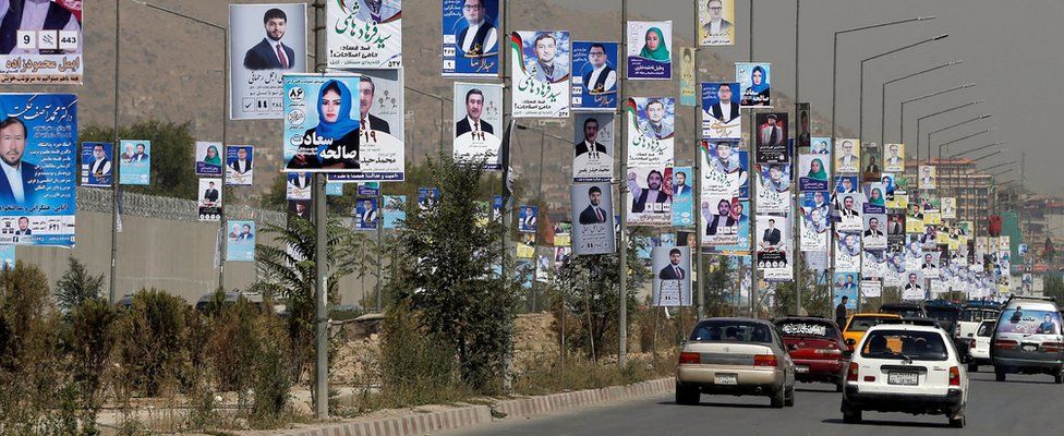Election posters of candidates are installed during the first day of election campaigning in Kabul