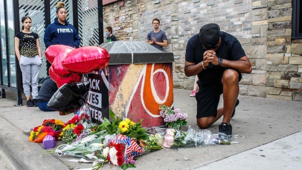 A protester prays in front of the memorial of George Floyd who died in custody on May 26, 2020 in Minneapolis, Minnesota