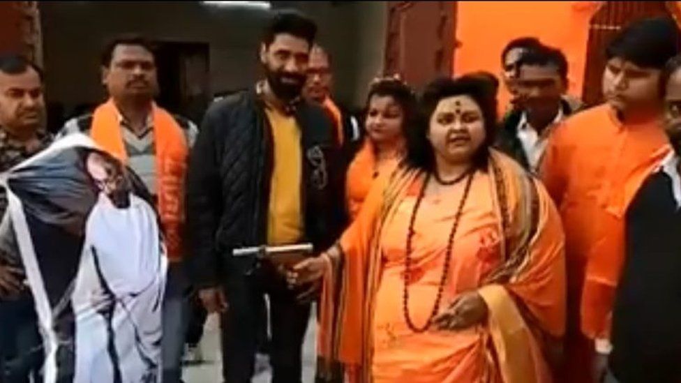 Pooja Pandey, leader of the Hindu Mahasabha, shooting at an effigy of Gandhi with an air pistol