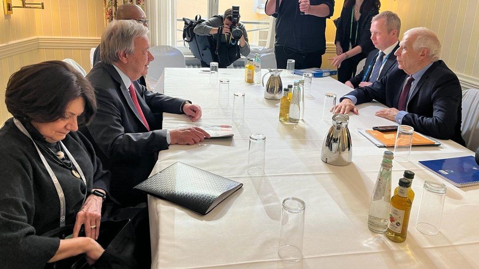 UN Secretary General António Guterres and EU top diplomat Josep Borrell sit around a table during a meeting