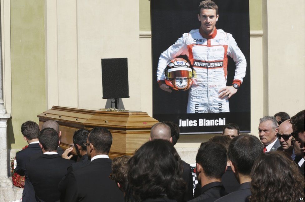 Pallbearers carry the casket of French Formula 1 driver Jules Bianchi into Sainte Reparate Cathedral during his funeral in Nice, French Riviera, Tuesday, July 21, 2015