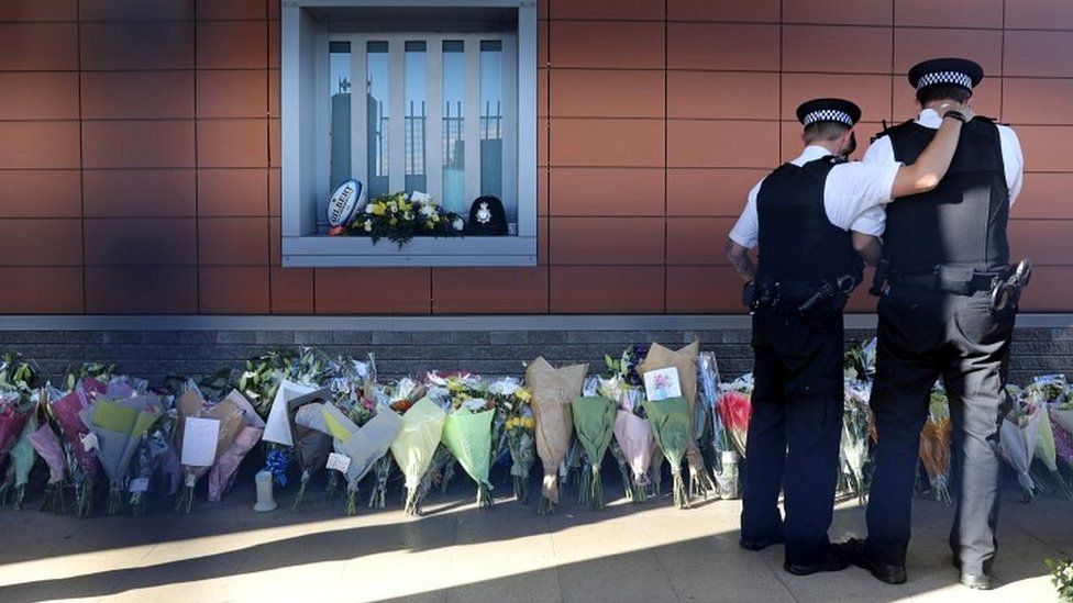 Police officer laying flowers