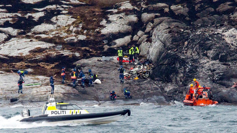 Police and rescue workers investigate at the scene following the Friday 29 April helicopter crash on the coast of Norway near Bergen, on Sunday 1 May 2016