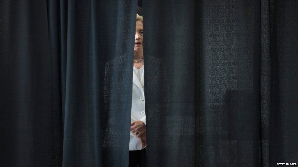 Democratic presidential candidate and former U.S. Secretary of State Hillary Clinton waits to be introduced at a campaign event on the campus of Des Moines Area Community College on August 26, 2015 in Ankeny, Iowa.