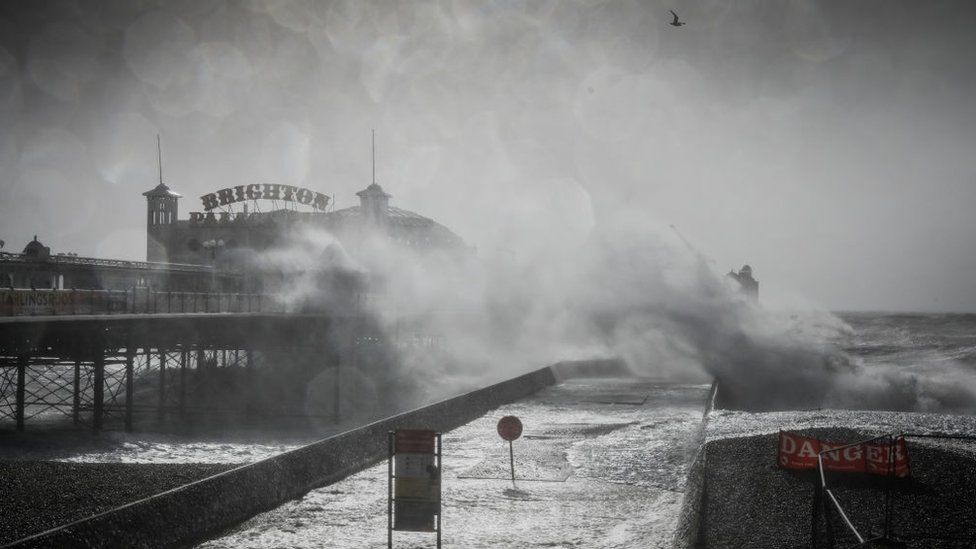 Waves crashing against Brighton pier during Storm Eunice