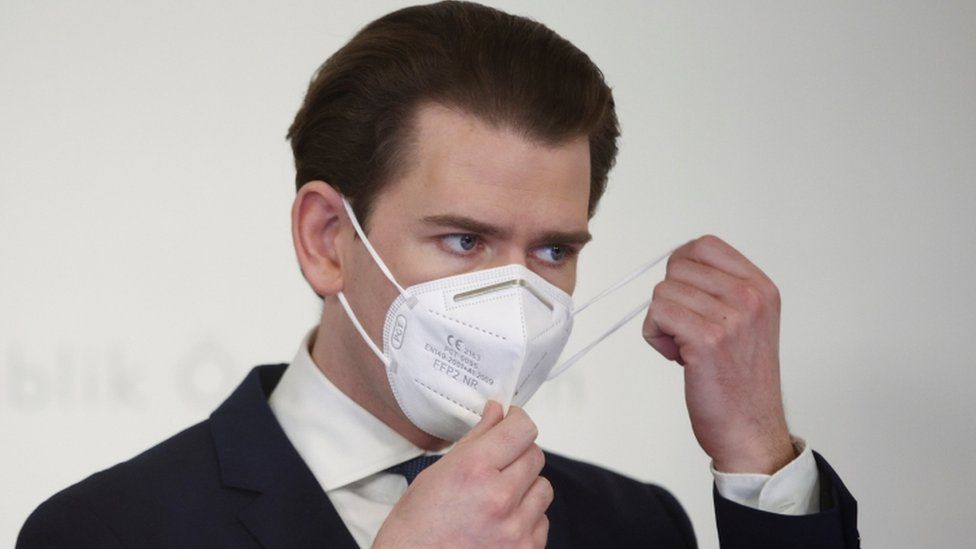 Austria's Chancellor Sebastian Kurz removes a face mask as he attends a news conference on 1 March