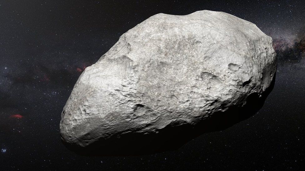 Artist's impression of a bright, pitted asteroid in front of a starry sky