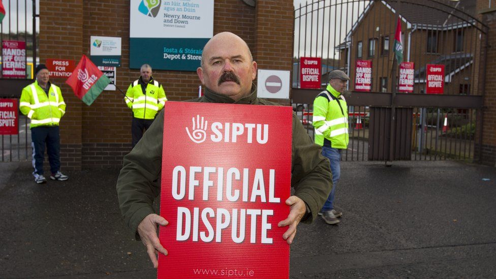 Man holding sign reading 'official dispute'