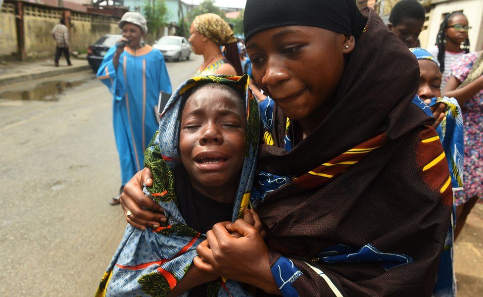 A young girl is comforted as she cries during a dramatisation of the crucifixion of Jesus Christ to mark Good Friday, heralding the start of Easter celebrations, in Lagos on March 30, 2018