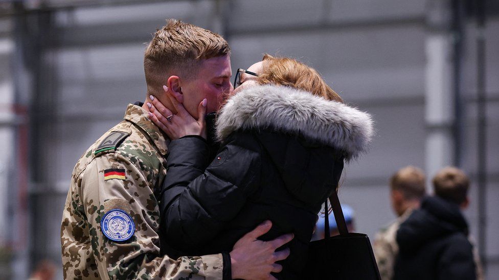 A German armed forces Bundeswehr soldier who had served under the UN mission in Mali, MINUSMA, kisses his partner after he landed at the military air base in Wunstorf, northern Germany, on December 15, 2023.