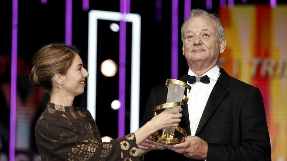 Bill Murray receives an award from US film director Sofia Coppola during an event to pay tribute to him at the opening ceremony of the 15th Marrakech International Film Festival in Marrakesh, Morocco (05 December 2015)