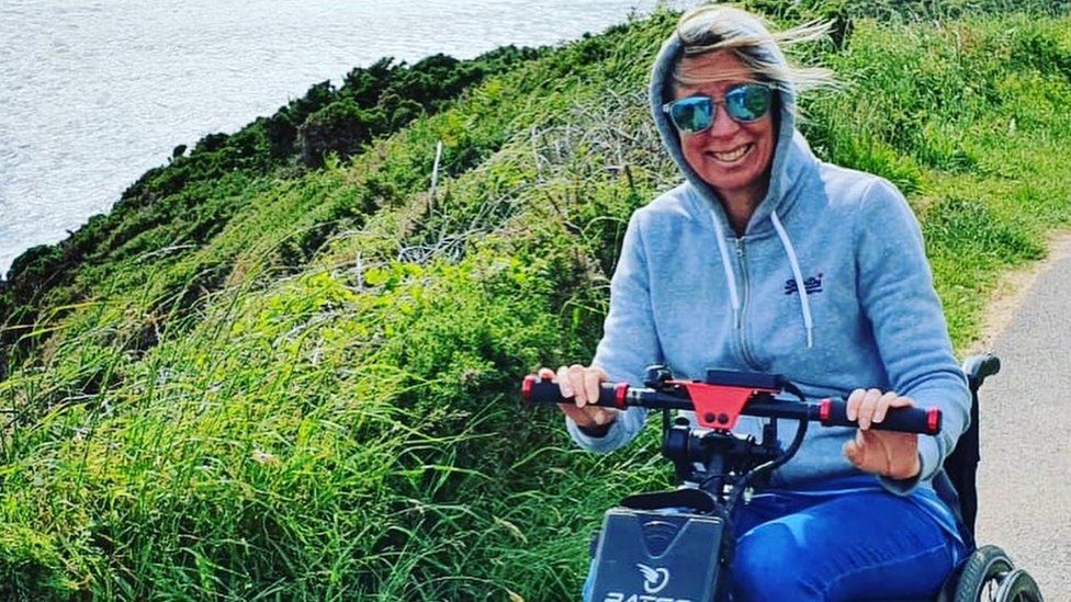 Amanda Harris on mobility scooter on coastal path