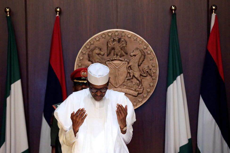 Nigeria"s President Muhammadu Buhari is seen prayi