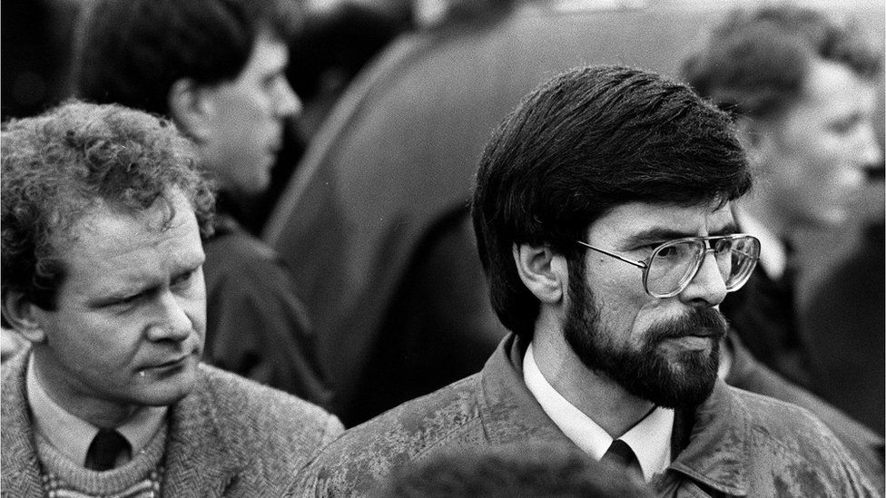 Sinn Fein President Gerry Adams (R) and his deputy, Mr Martin McGuinness look on as the hearses carrying the coffins of IRA members, Mairead Farrell, Daniel McCann and Sean Savage [IRA operatives killed in Gibraltar], set off from Dublin Airport heading for Belfast. Picture taken on 14/03/1988