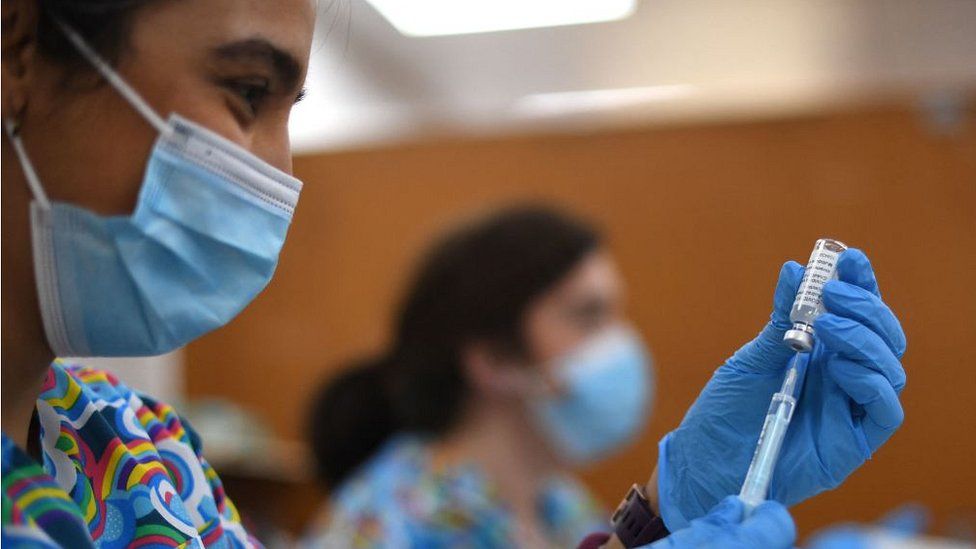 health worker preparing vaccine