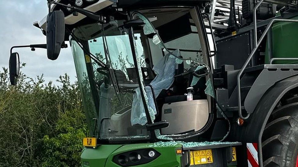 Smashed window on a combine harvester