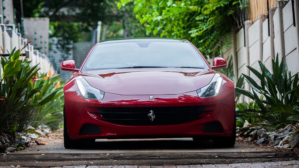 A Ferrari F151 drives off from the Blackhead Consulting offices in Bryanston, Johannesburg, 6 October 2020, after seized by Assets Forfeiture Unit (AFU)
