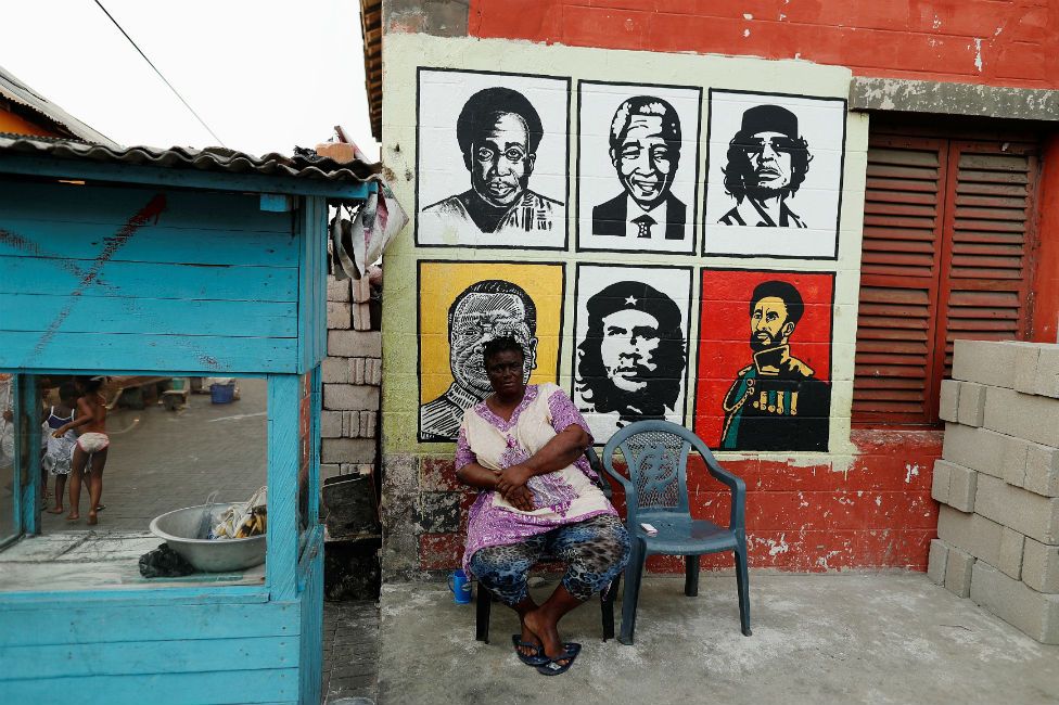 A street vendor sits beside her stall in Jamestown, Accra, Ghana - 28 November 2018