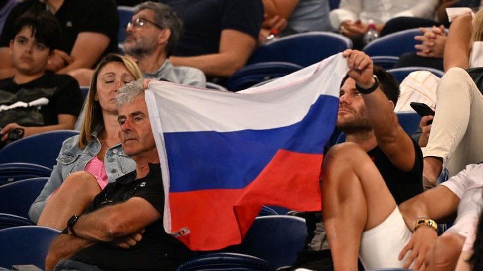 A spectator holds a Russian flag at the Australian Open