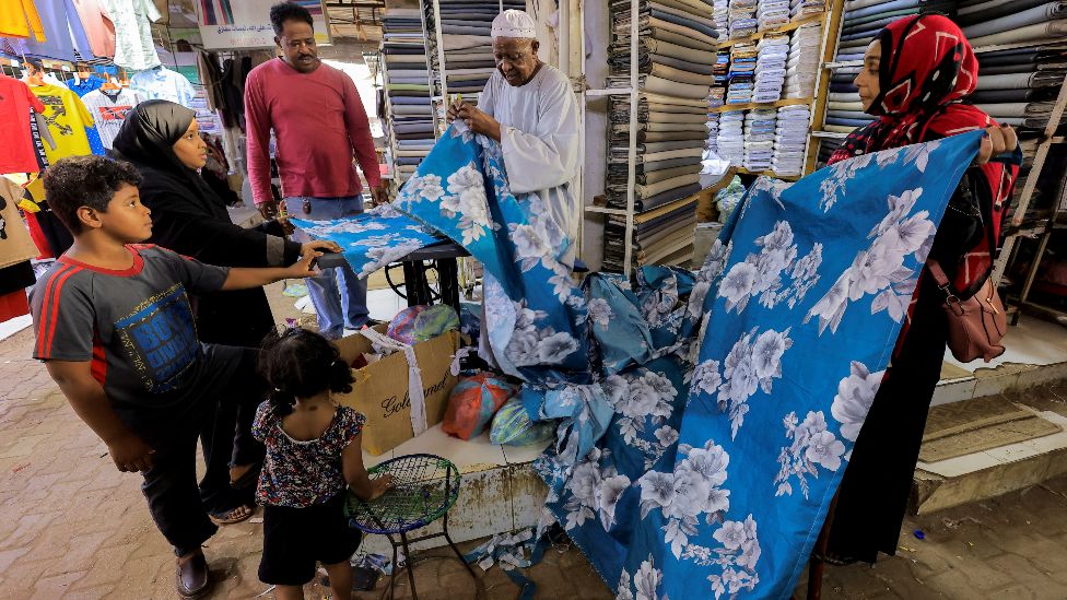 A family looking at material in a shop in Khartoum, Sudan - Friday 29 April 2022