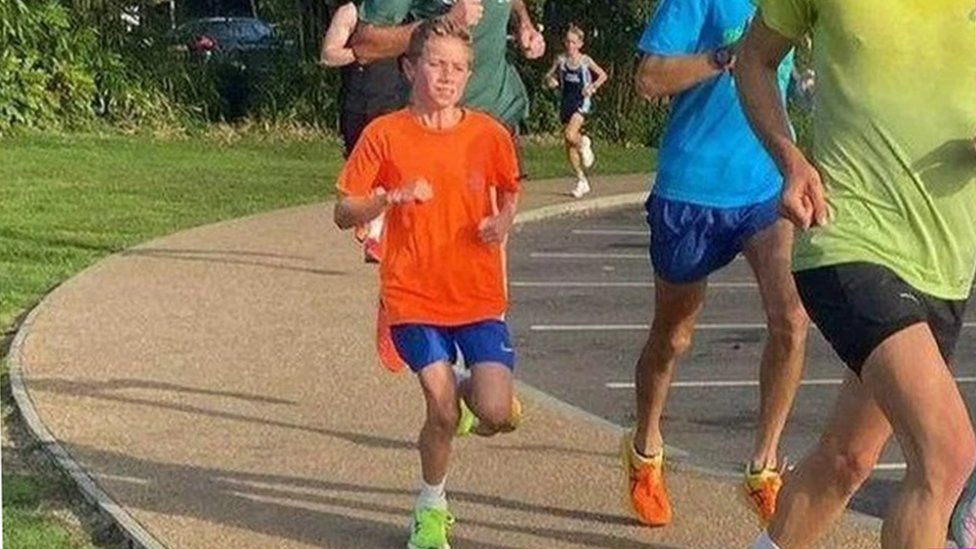 Lewis running with other Parkrunners