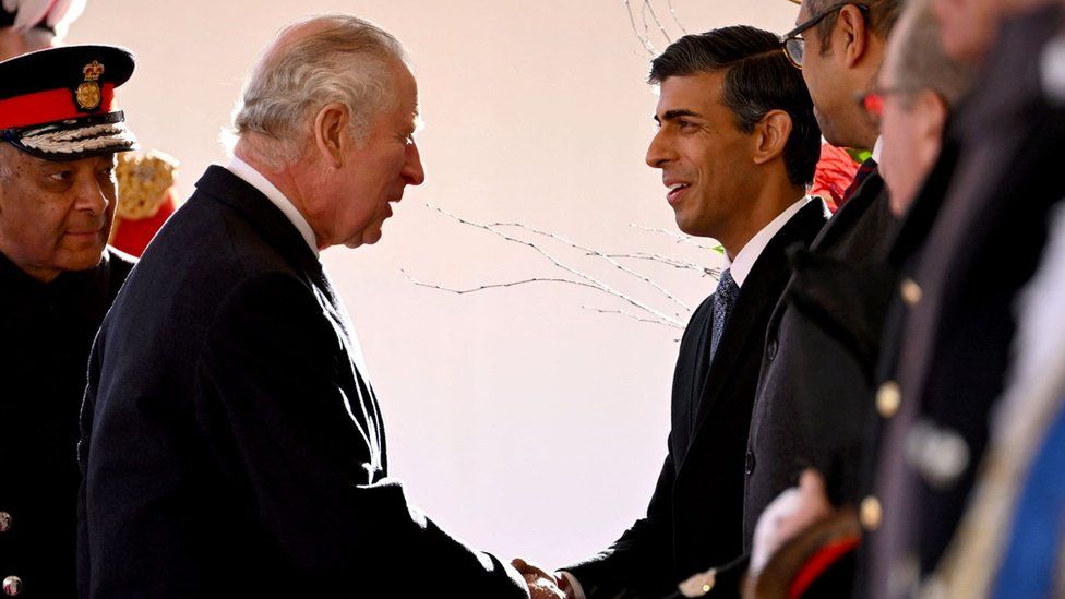 King Charles shakes Rishi Sunak's hand