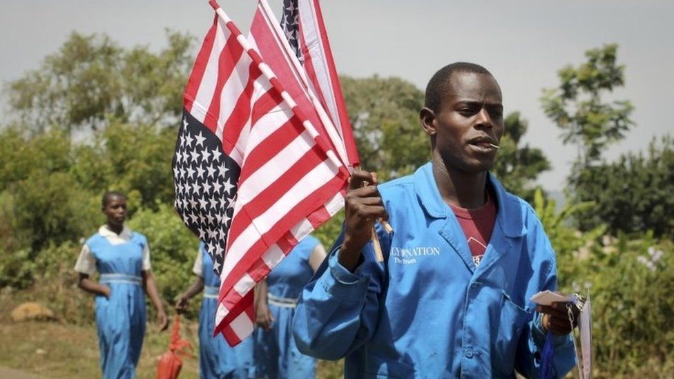A vendor sells American flags at an event attended by Sarah Obama