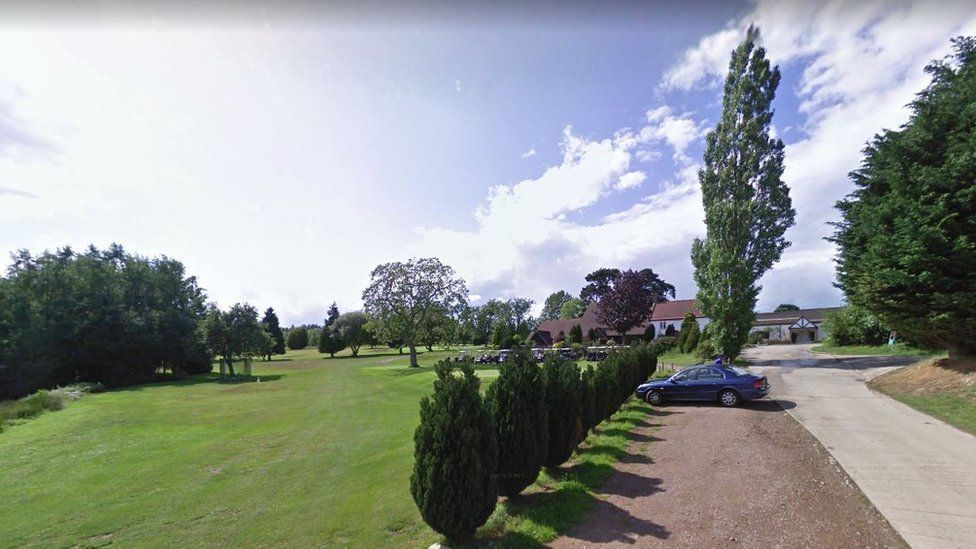 The golf course and buildings on the right side