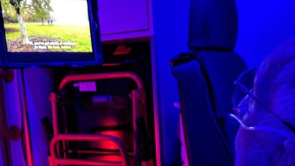 Mervyn Jones inside an ambulance watching TV on an iPad