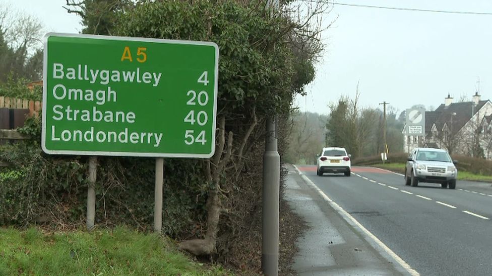 Cars pass a road sign on the A5