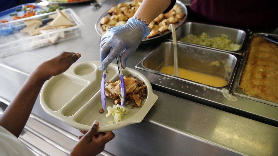 a child being served a canteen dinner