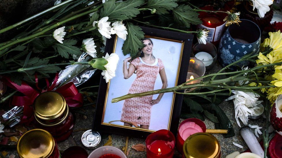 Flowers and candles are placed near a portrait of slain Bulgarian television journalist Viktoria Marinova in the city of Ruse on October 9, 2018.