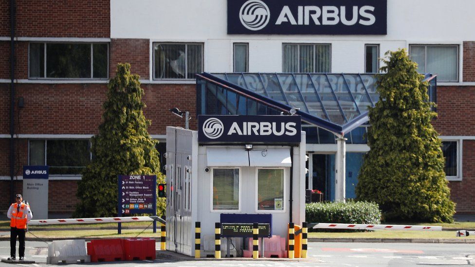 A security guard standing outside Airbus in Broughton, Flintshire
