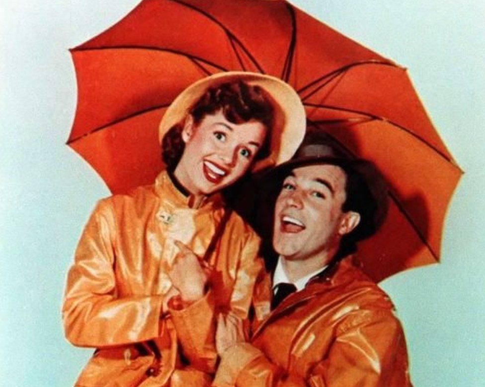 This undated file photo shows US actor Gene Kelly, who died 02 February at the age of 83 at his home in Beverly Hills, California, with actress Debbie Reynolds from the movie "Singin" in the Rain
