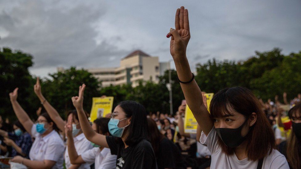 Thai people hold up a three finger salute at an anti-government protest on August 10, 2020 at Thammasat University in Bangkok, Thailand.